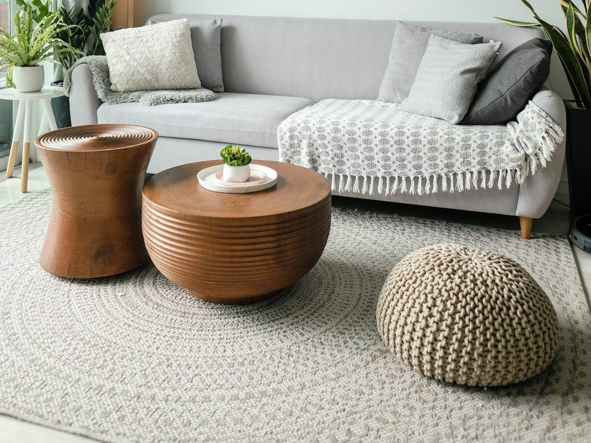 Bright, tidy living room with a grey sofa, ready for a showing